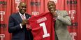 Arthur Johnson pictured with President Wingard, holding Johnson's replica Temple jersey.