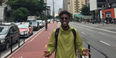 Xavier Burke standing at the center of a busy road in Sao Paulo, Brazil.