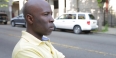 A man in a yellow shirt standing on a film set.