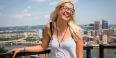 Freshman Emma Dowker smiling with the Pittsburgh skyline behind her. 