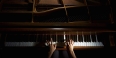Hands playing a piano.  