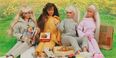 A photo of Barbie dolls having a picnic.