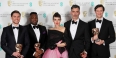four men and a woman holding British Academy of Film and Television Arts awards.