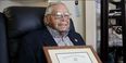 Nelson Henry Jr. holding his honorable discharge certificate.