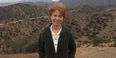 Nora Newcombe standing in front of a desert landscape