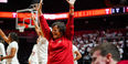 Image of Temple University’s Coach Diane Richardson smiling and raising her hands during a college basketball game.
