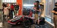 Image of Temple Formula Racing students showing others their 2018 race car.