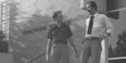 Image of two people walking down the steps of Tomlinson Theater. 