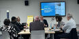 An image of folks around a table at a budget workshop.
