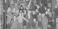 Image of children outside Mr. Joe Grimm’s store the day after three men were shot there, two fatally.