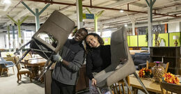 Students hold chairs in a ReStore
