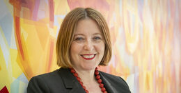 Erika Tapp Duran standing against a colorful background