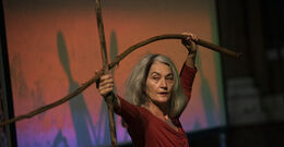 Merián Soto holding branches as part of her choreography 