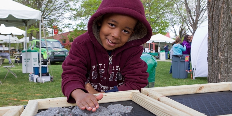 A child plays outside at Temple’s Earth Fest.