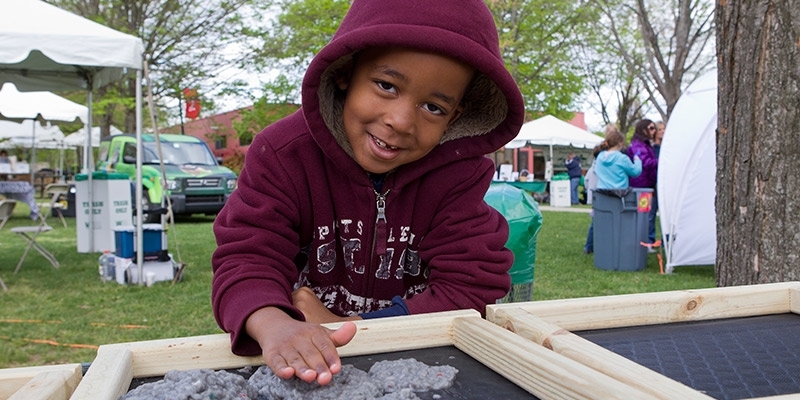 A child plays outside at Temple’s Earth Fest. 