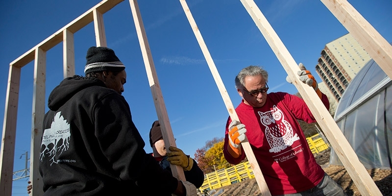 Temple volunteers framing a house on Global Day of Service.