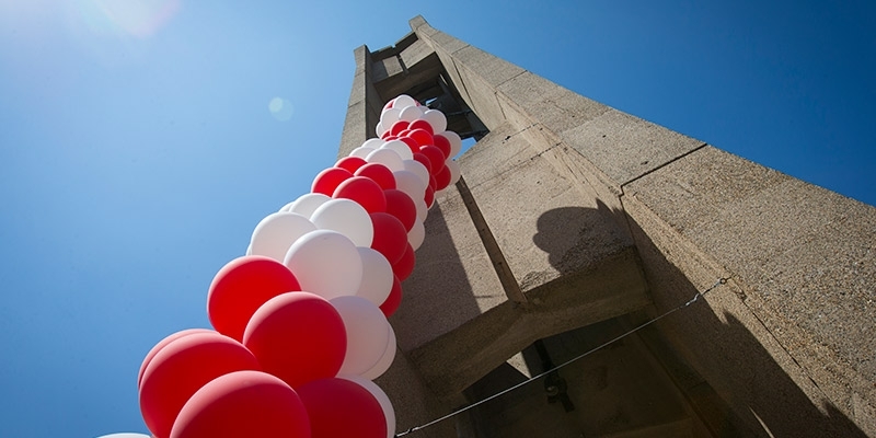 Cherry and white balloons decorating the bell tower. 