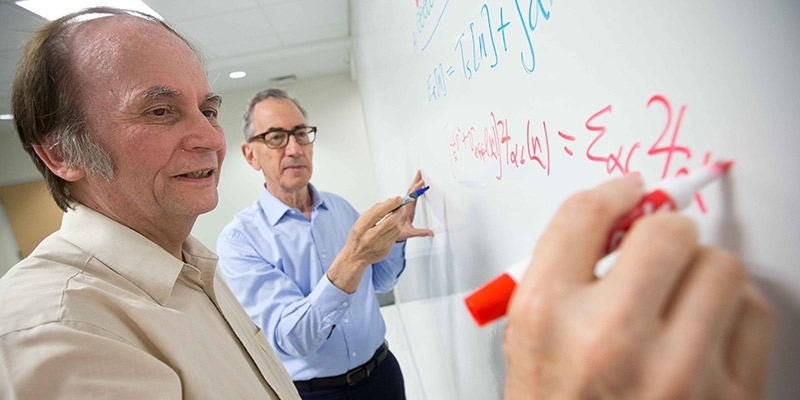 John Perdew working with the dean of the College of Science and Technology.