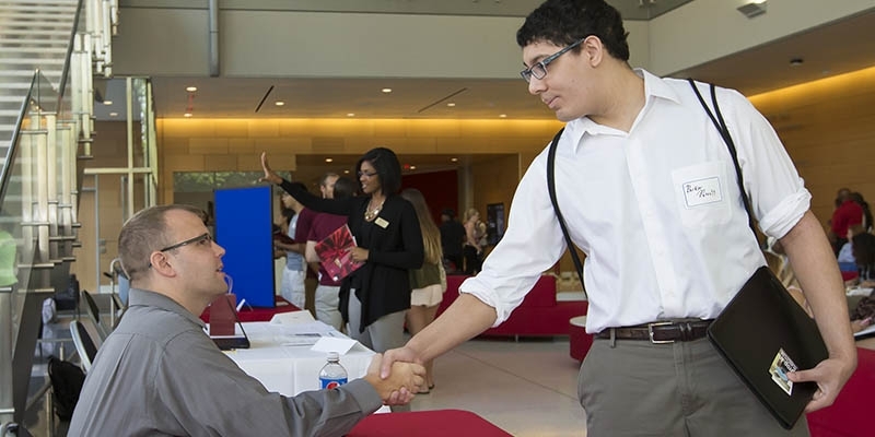 Student shaking hands with prospective employer.