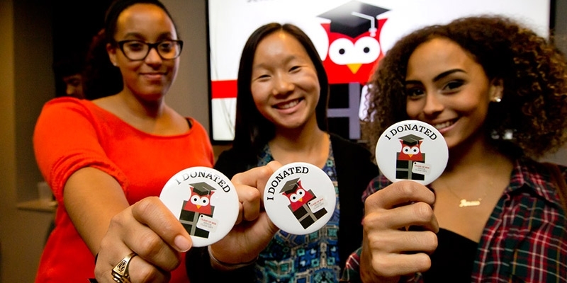 Temple students show off their “I donated” buttons at the Senior Class Gift launch party.