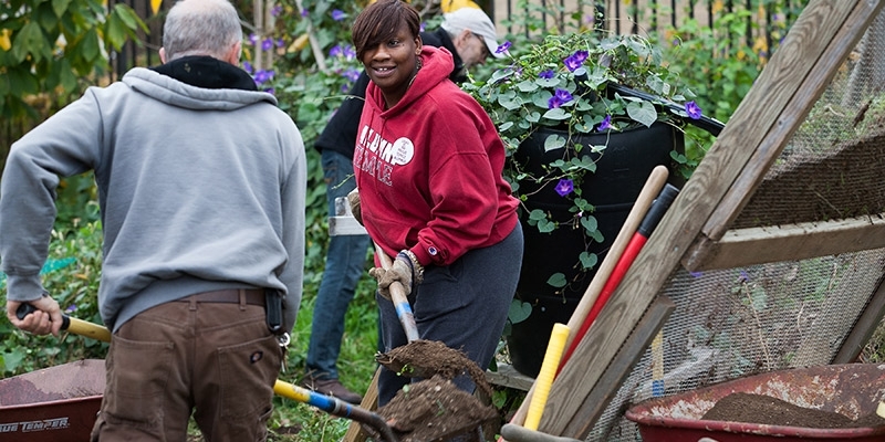 Temple volunteers working in a community garden on Global Day of Service.