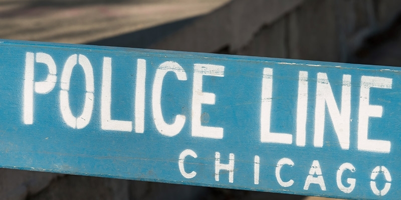 A wooden, blue police line barricade in Chicago.