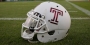 A white Temple football helmet with a cherry Temple "T"