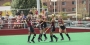 Temple’s field hockey team celebrating on the field. 