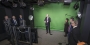 A group of administrators looking at the green screen set up in the film studio.