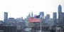 The US flag flying against the Philadelphia skyline.