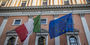 Image of the Italian and European flags on a building.