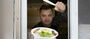 A food truck vendor shows off a meal