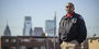 Image of a man in a Temple Police officer jacket outside in North Philadelphia.