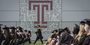 Graduates on the field at Edberg-Olson Athletic Hall during Commencement. 