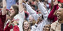 People cheering in the stands at Homecoming