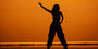 A student's silhouette shown performing at a Temple dance concert