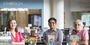 Professors Christina Baker, César Cabezas and Augusto Lorenzino standing in front of books on display in Charles Library for Hispanic Heritage Month