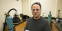 Image of Mehdi Khanzadeh holding a sample of carbonatable concrete.