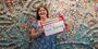 Abigail McNavage holding a #TempleMade sign in front of her painting 