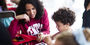 Image of a child with a parent wearing cherry white shirts at Temple.