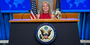 Mergen at State Department podium