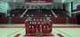  Image of Temple’s dance team wearing cherry and white posing in front of trophies.  