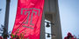 Image of a Temple logo flag on campus. 