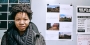 Rasheedah Phillips standing in front of a wall with a calendar and posters.