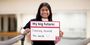 Smith holds a sign reading "My big future: Dancing around the world :)" in a dance studio