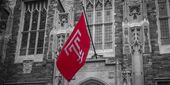 Image of a Temple flag flying on Main Campus.