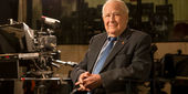 Lew Klein sitting in a TV studio