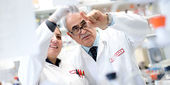 Kamel Khalili and researcher in lab