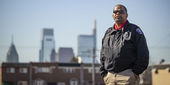 Image of a man in a Temple Police officer jacket outside in North Philadelphia.