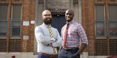 Image of the principal and assistant principal outside of Paul L. Dunbar Elementary School.